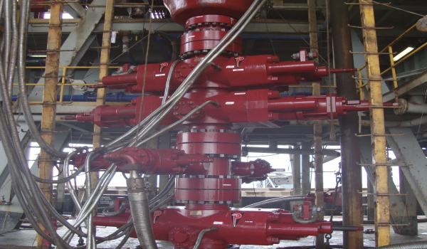 Technicians performing inspection and maintenance on offshore blowout preventer system