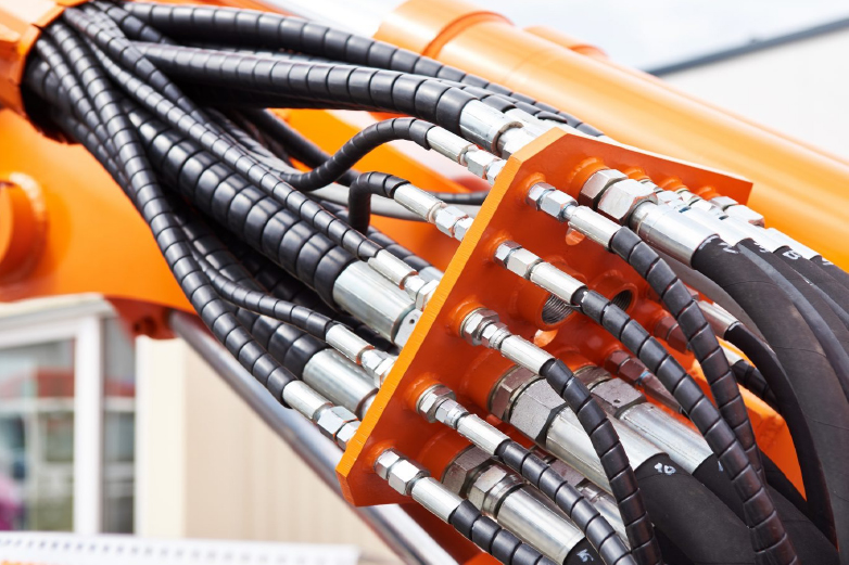 Hydraulic engineers rebuilding industrial hydraulic systems and power units in a workshop environment