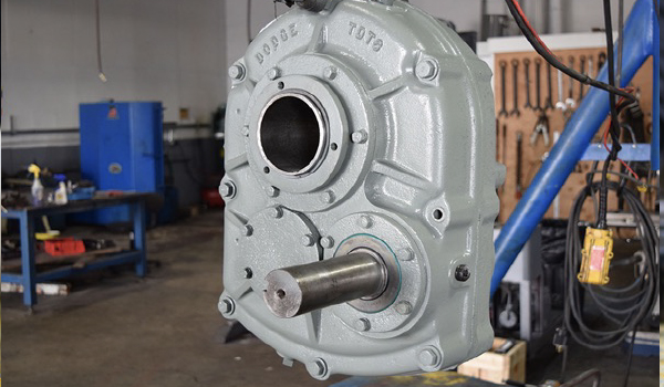 Industrial gearbox being inspected and repaired in workshop overhaul facility
