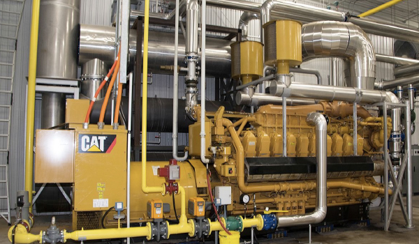 Technician performing maintenance and diagnostics on industrial generator engine system
