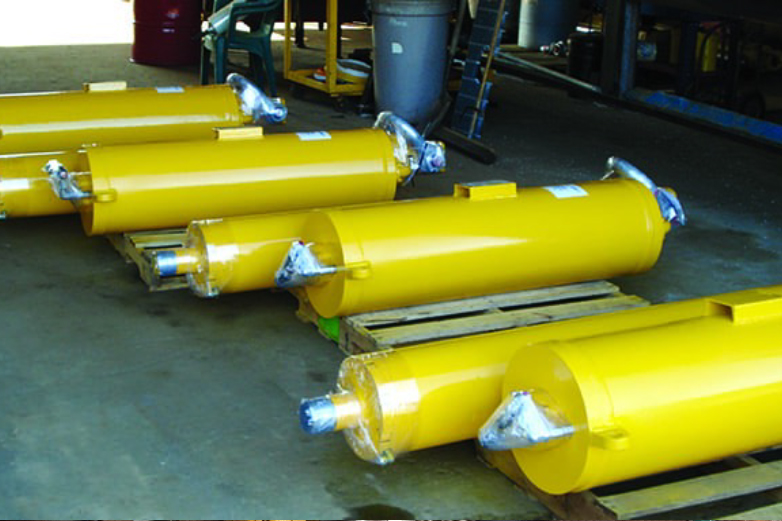 Hydraulic cylinder being dismantled and reconditioned in an industrial workshop