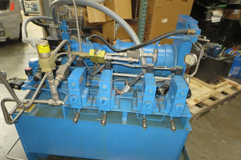 Hydraulic Power Unit undergoing testing and maintenance in an industrial workshop