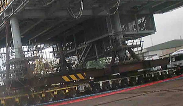 SPMT load-out operation moving a heavy offshore module to a quay