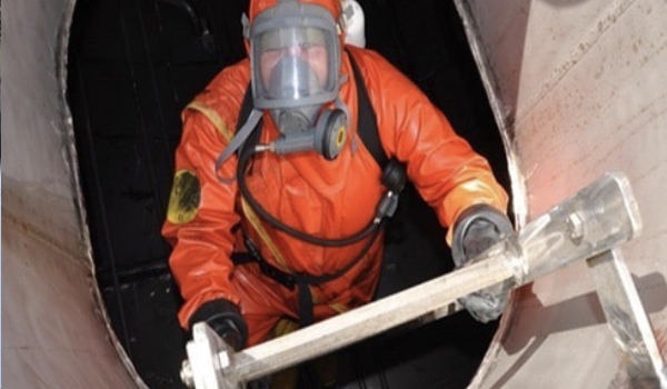 Technicians performing offshore rig mud system and tank cleaning operations