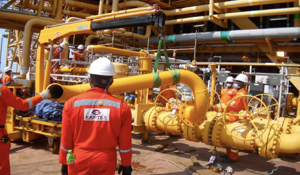Pipeline technicians performing inspection and repair operations on oil and gas pipeline system