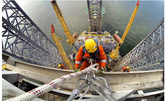 Industrial rope access technicians performing offshore inspection and maintenance work
