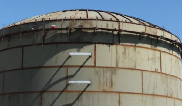 Industrial storage tank undergoing repair and structural modification activities
