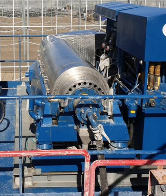 Drilling waste management equipment processing drill cuttings and recovering drilling fluids at an oilfield location.